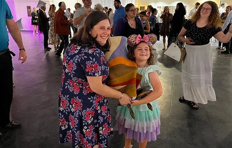 rabbi and young girl holding torah